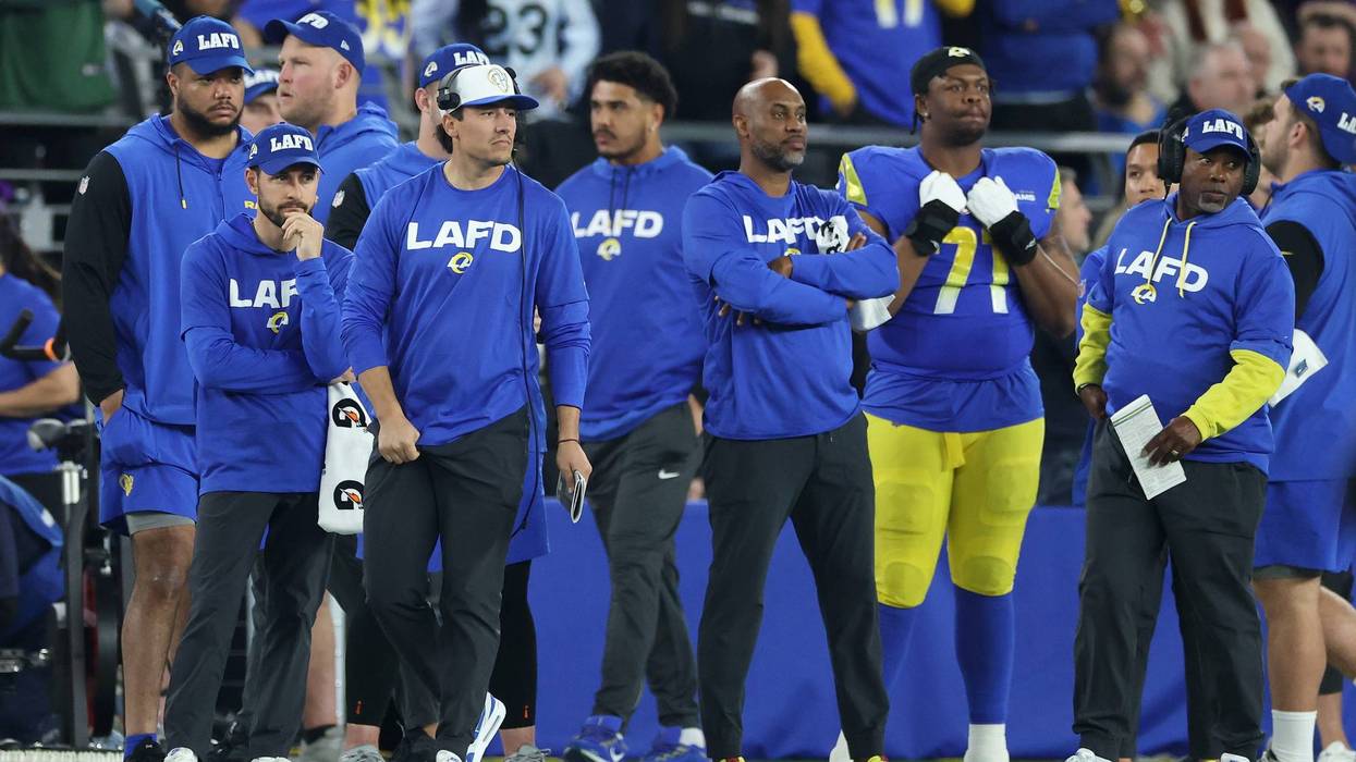 GLENDALE, ARIZONA - JANUARY 13: The Los Angeles Rams coaching staff look on while wearing LAFD shirts during the third quarter against the Minnesota Vikings during the NFC Wild Card Playoff at State Farm Stadium on January 13, 2025 in Glendale, Arizona.
