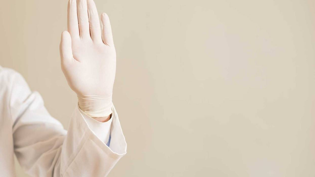 Gloved hand raised as if saying "no."