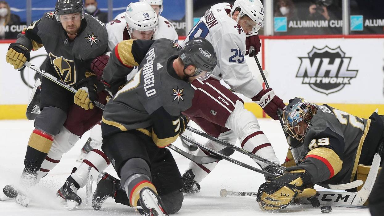 Goalie Marc-Andre Fleury #29 of the Las Vegas Knights makes a save against Nathan MacKinnon #29 of the Colorado Avalanche in the second period at Ball Arena on February 22, 2021 in Denver, Colorado.