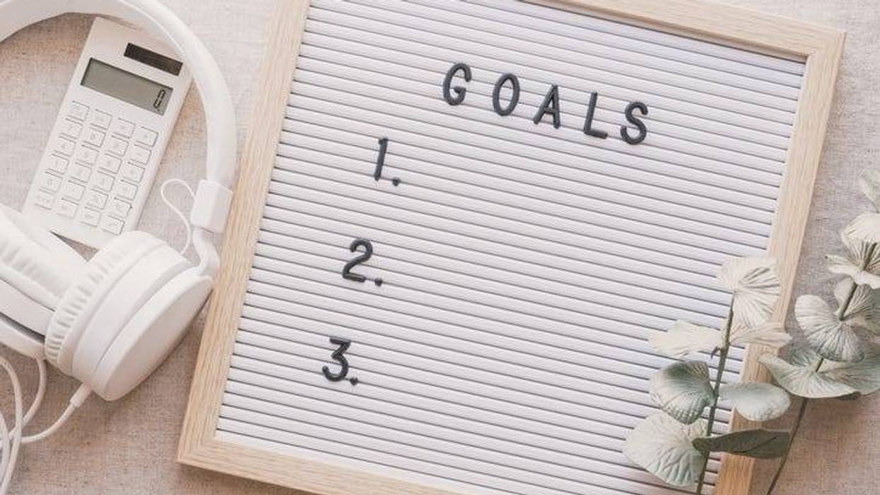 Goals board with headphones and a calculator