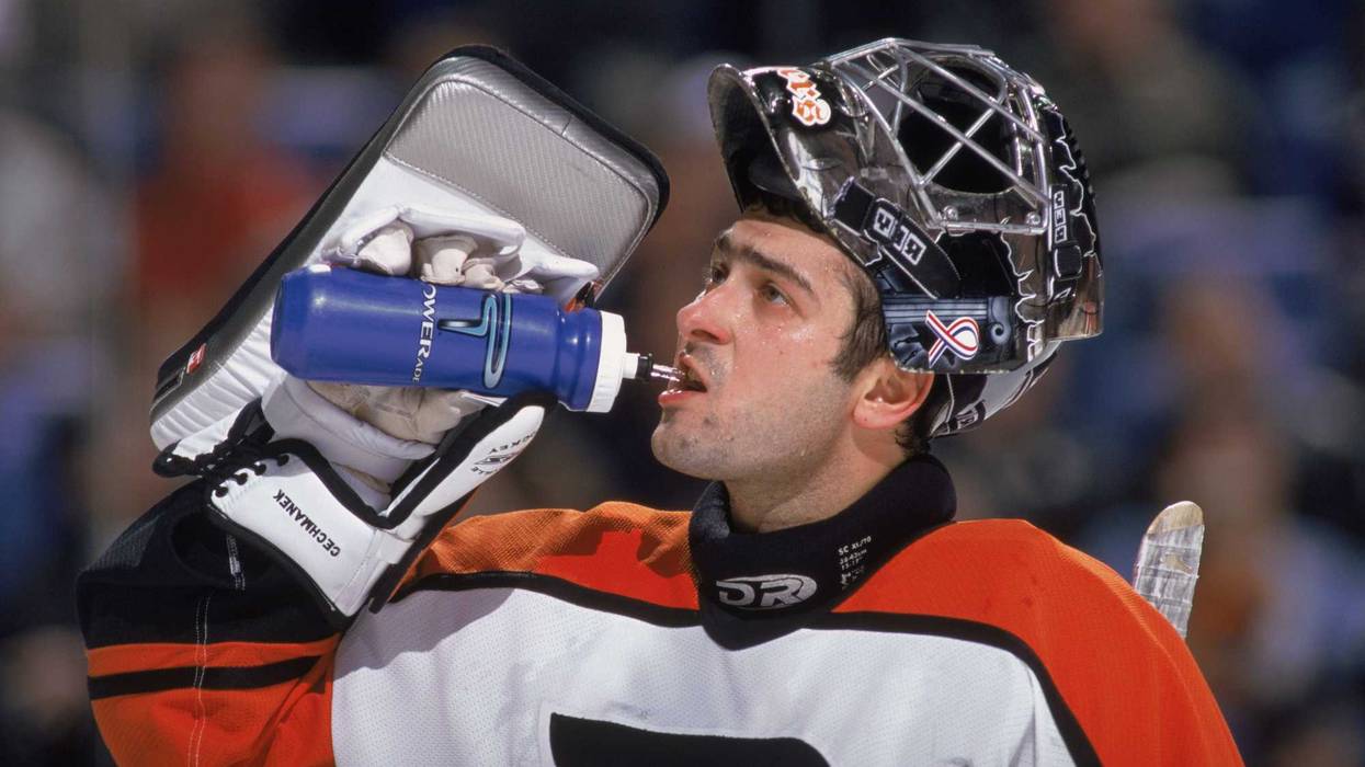 Goaltender Roman Cechmanek, #32 of the Philadelphia Flyers, drinks water during the NHL game against the Buffalo Sabres at the HSBC Arena in Buffalo, New York, April 1, 2002.