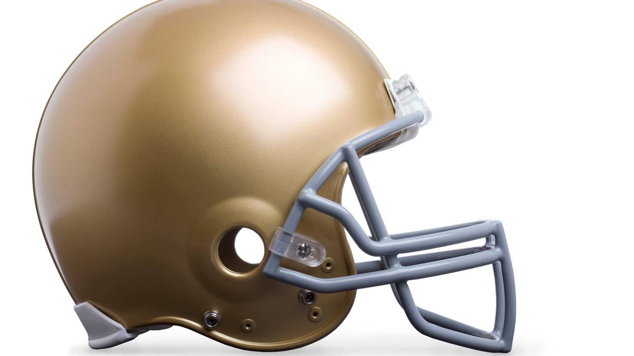 Gold football helmet isolated on white