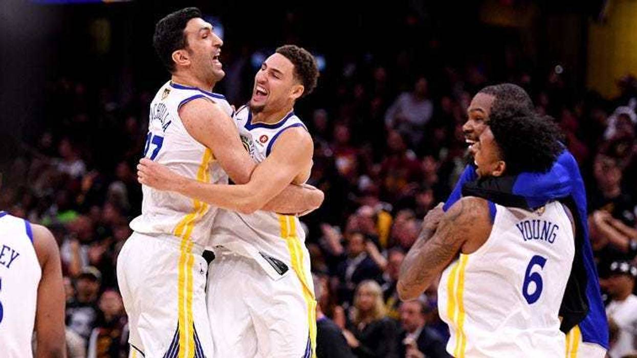 Golden State Warriors center Zaza Pachulia (left) celebrates with teammate Klay Thompson (11) after beating the Cleveland Cavaliers in Game 4 of the NBA Finals at Quicken Loans Arena in Cleveland.