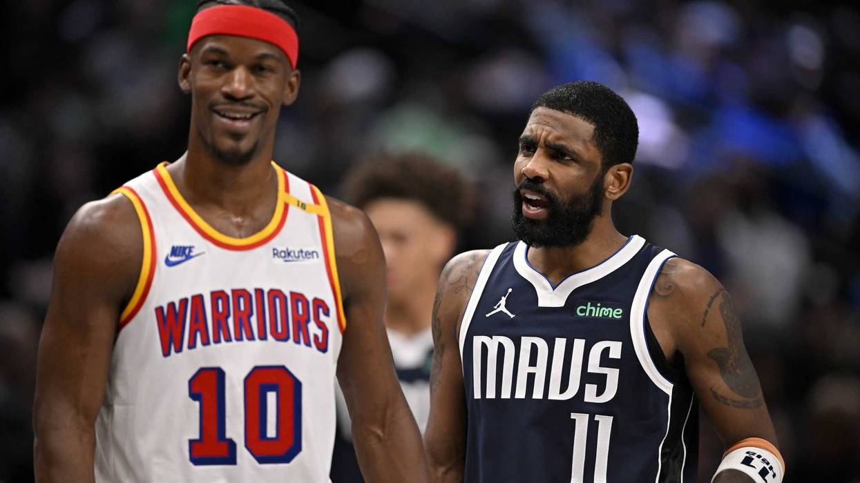 Golden State Warriors forward Jimmy Butler (10) laughs as Dallas Mavericks guard Kyrie Irving (11) argues a call during the second half at the American Airlines Center.