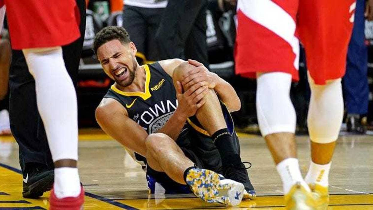Golden State Warriors guard Klay Thompson reacts after an injury against the Toronto Raptors in gGame 6 of the NBA Finals on June 13, 2019, at Oracle Arena in Oakland, California.
