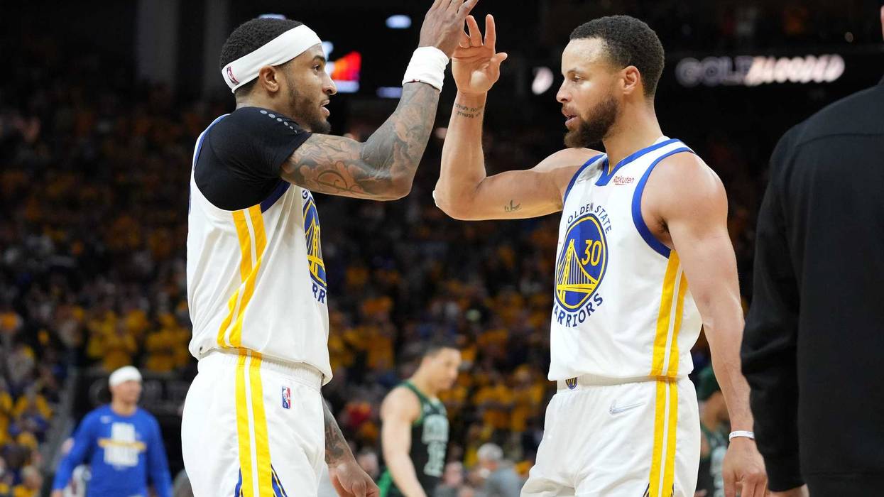 Golden State Warriors guard Stephen Curry (30) celebrates with guard Gary Payton II (left) after defeating the Boston Celtics