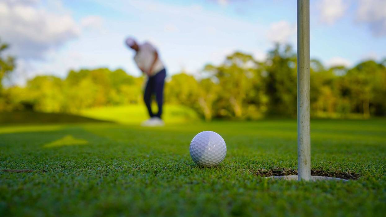 Golfers are putting golf in the evening golf course golf backglound.