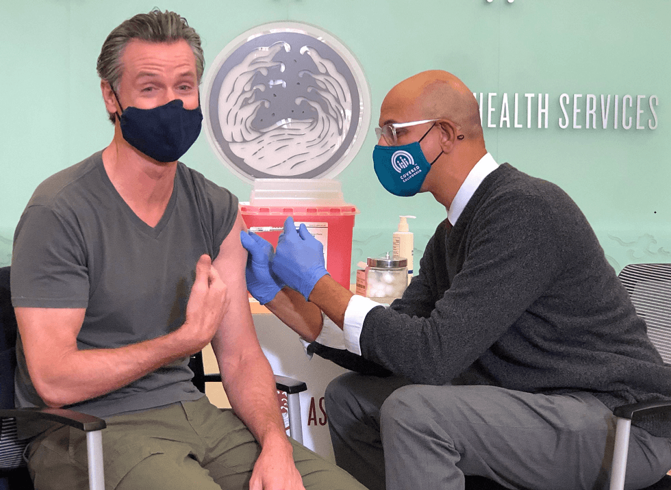 Gov. Gavin Newsom gets his COVID-19 booster shot at an event in Alameda County.