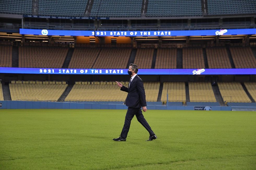 Gov. Gavin Newsom walks off the field at Dodger Stadium in Los Angeles following Tuesday