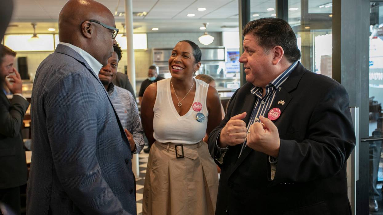 Gov. J.B. Pritzker, right, speaking with Attorney General Kwame Raoul and Lt. Gov. Juliana Stratton.
