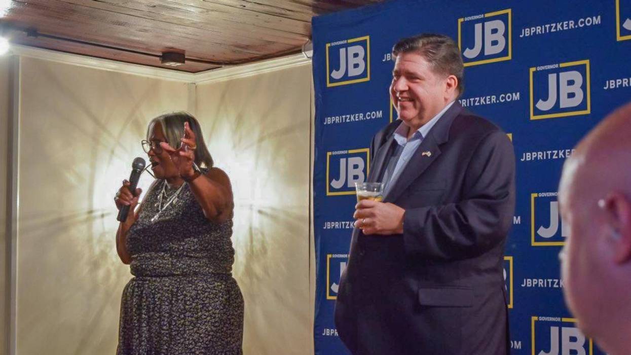 Gov. JB Pritzker holds a branded craft “JBeer” on stage at a Springfield campaign kickoff event alongside local state Sen. Doris Turner.