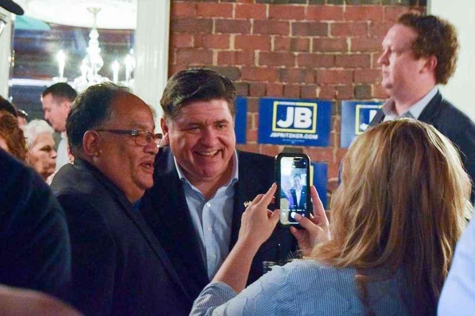 Gov. JB Pritzker takes a picture with Mike Lopez, mayor of nearby Jerome, after announcing his reelection campaign in Springfield on Thursday, June 26.