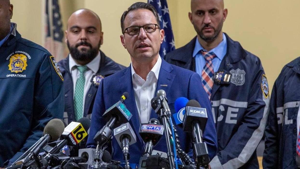 Gov. Josh Shapiro, center, speaks during a press conference regarding the arrest of suspect Luigi Mangione on Monday in Hollidaysburg, Pa.