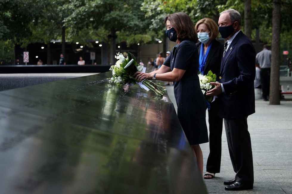 Gov. Kathy Hochul and former Mayor Mike Bloomberg are joined by 9/11 Memorial & Museum president Alice Greenwald as they lay flowers at the edge of the south memorial pool to commemorate the 20th anniversary of the September 11 terror attacks on September 08, 2021