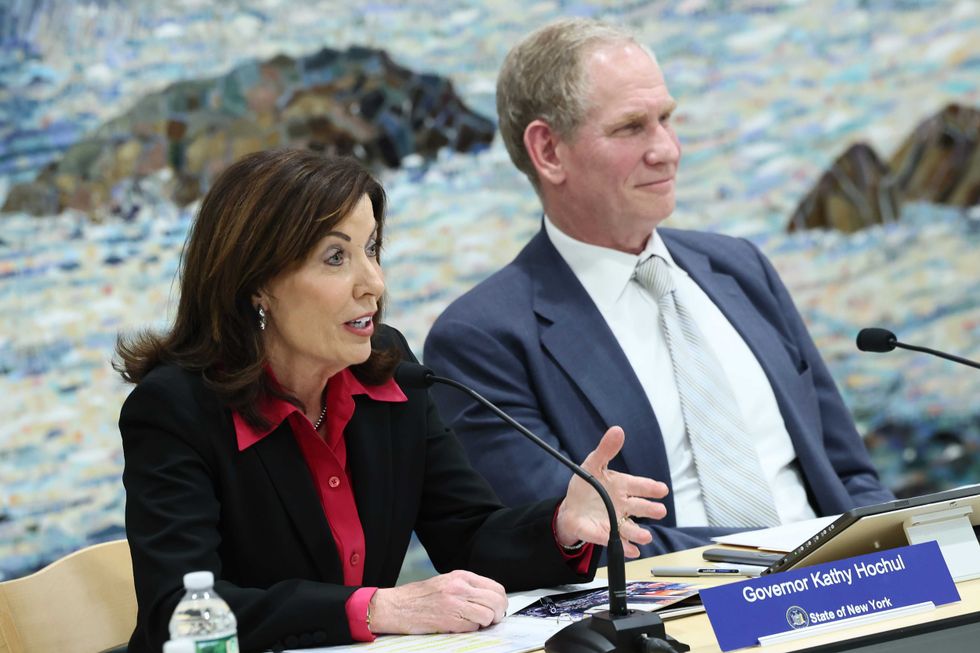 Gov. Kathy Hochul speaks as Janno Lieber, Chair & CEO at New York Metropolitan Transportation Authority, listens on during the MTA Board