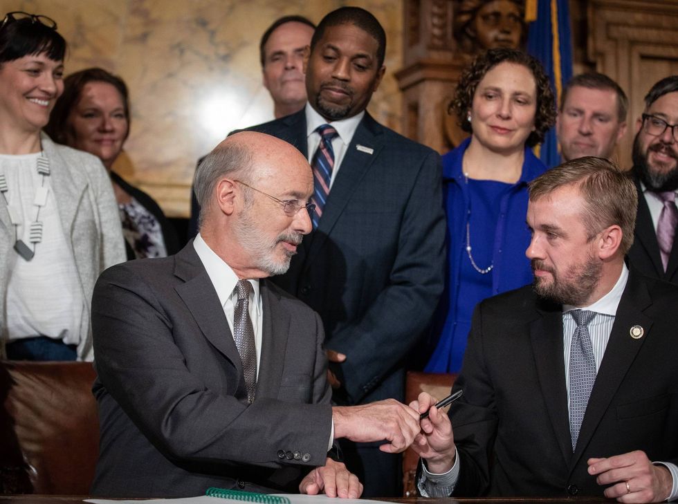 Gov. Tom Wolf and state Rep. Bryan Cutler (R., Lancaster) shook hands after the signing of Act 77.