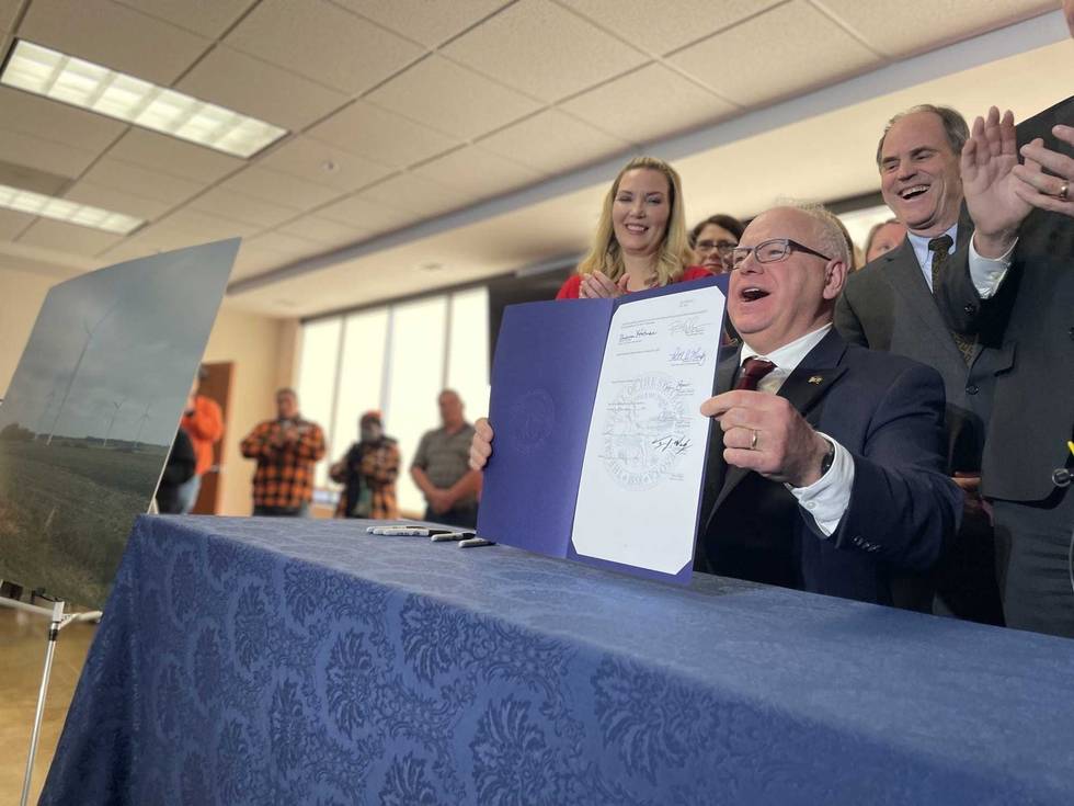 Gov. Walz singing the Clean Energy Bill.