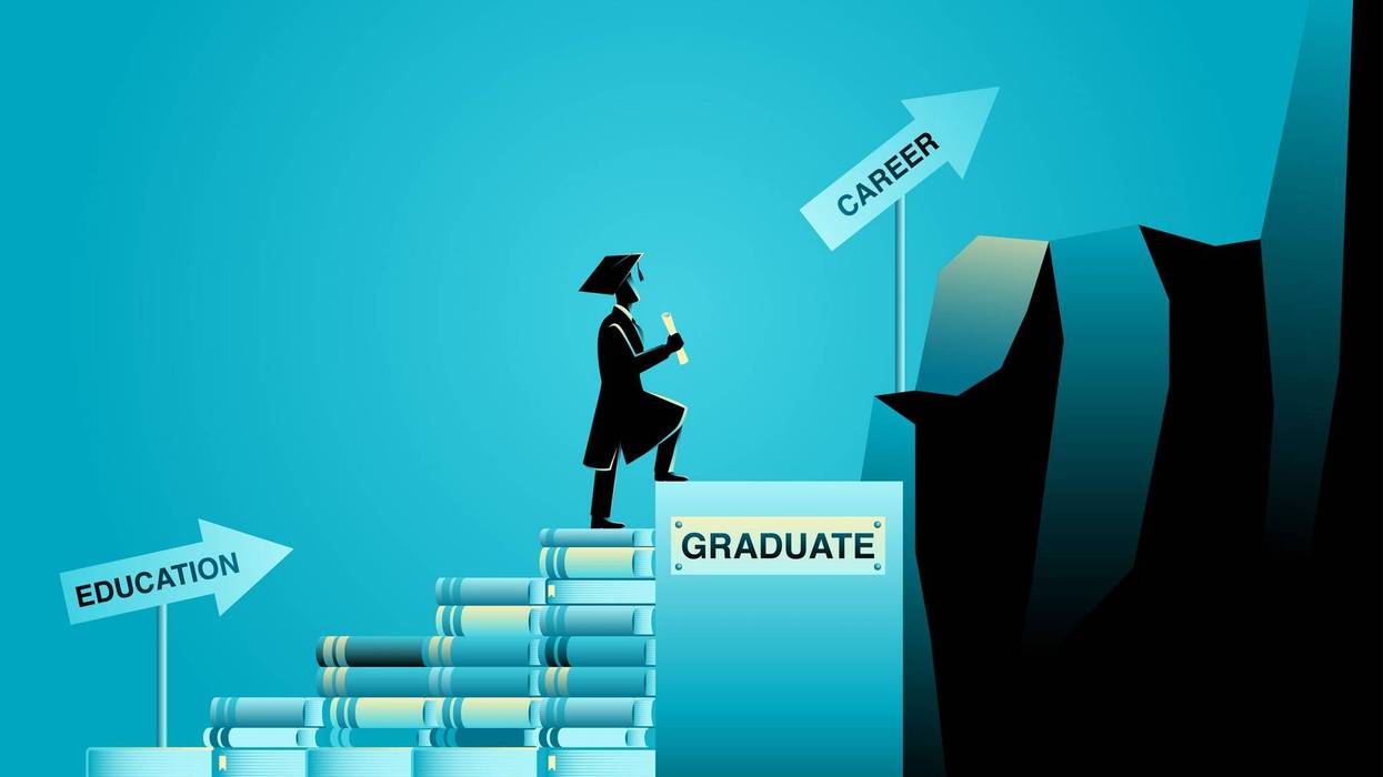 graduate climbing a stack of books to get their career