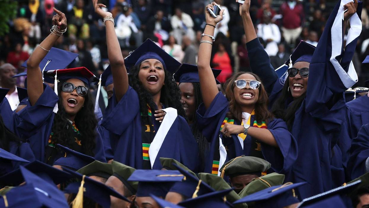 Graduates celebrate at a Howard University commencement ceremony.