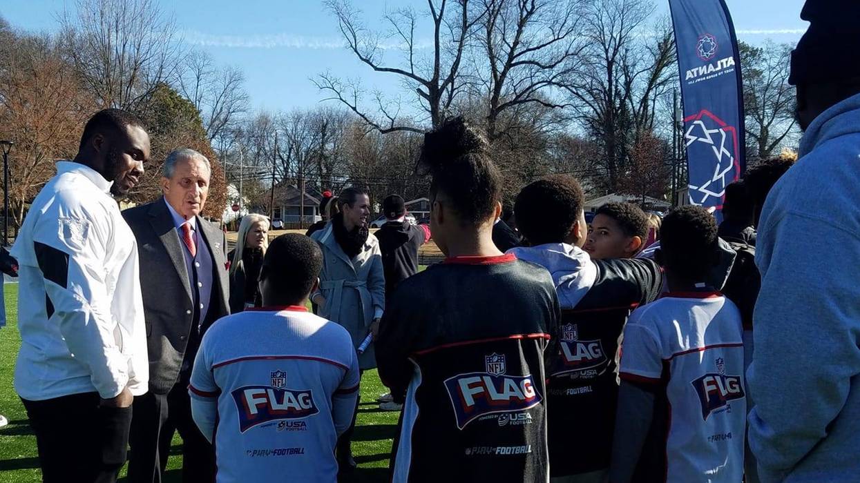 Grady Jarrett and Falcons Owner Arthur Blank chat with students at the newly renovated John F. Kennedy Park in Vine City.