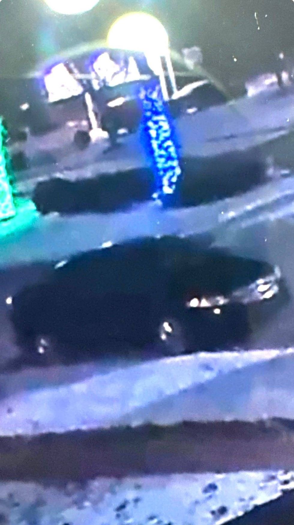 Grainy footage of black car