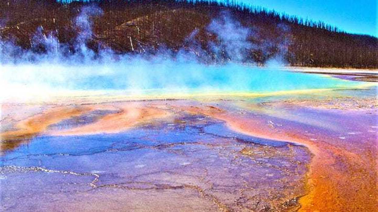 Grand Prismatic Spring - Yellowstone NP, WY - stock photo Hot spring with all the colors of a paint pot: glacier blue, brown, burnt orange, yellow and gun metal blue. All of this in beautiful swirls and curls and white steam rising from the water.