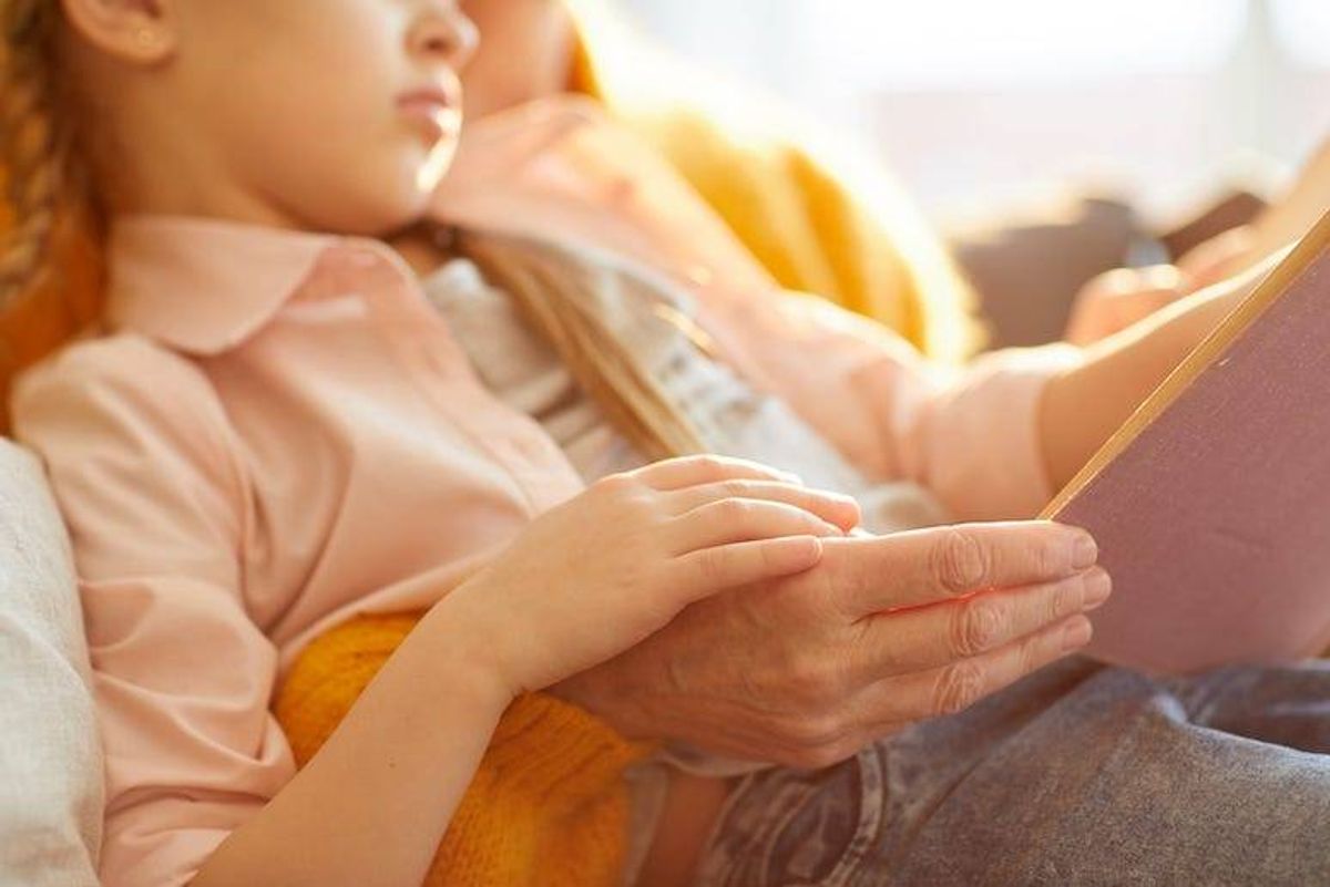 Grandma reading story to granddaughter