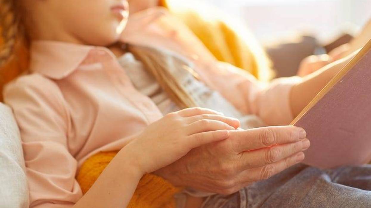 Grandma reading story to granddaughter