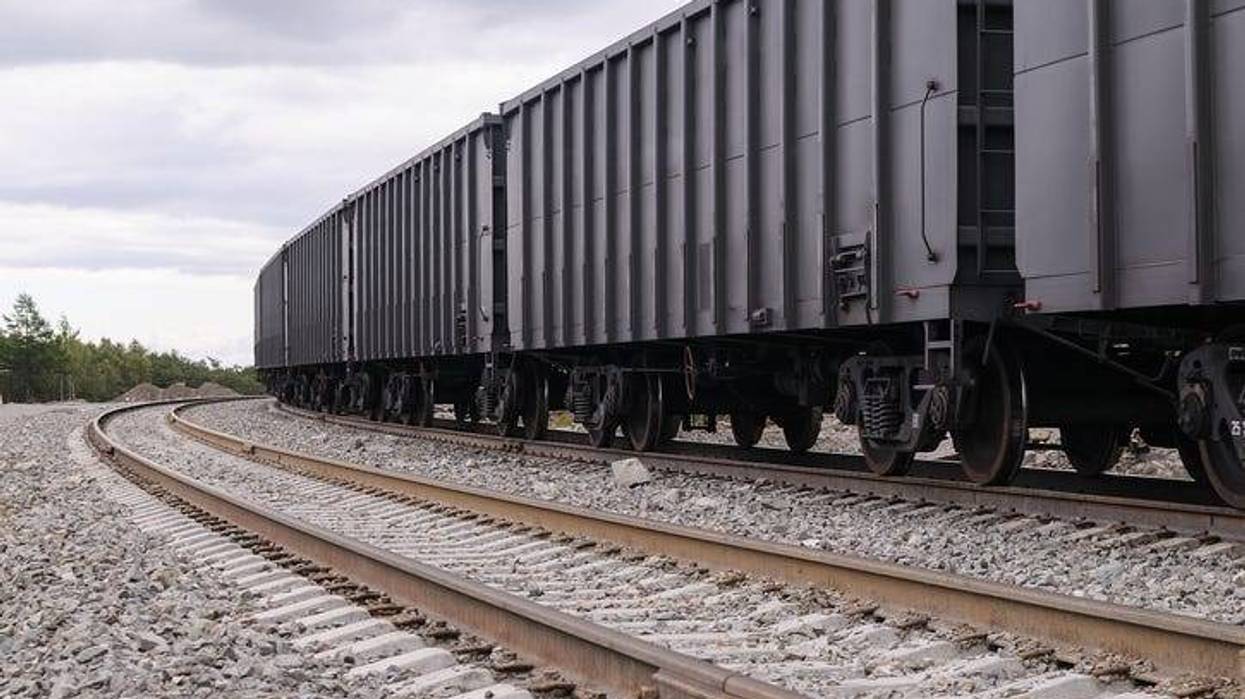 Gray Rail Cars Travel Down Train Tracks - Getty Images