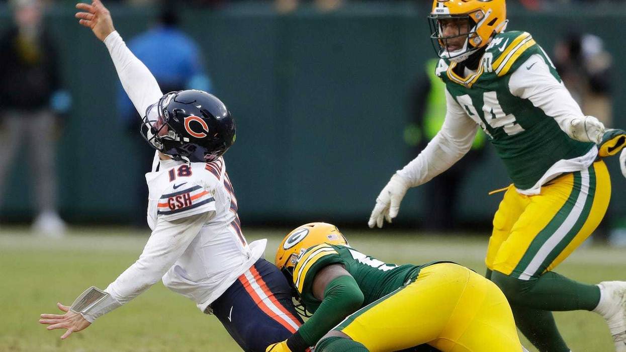 Green Bay Packers linebacker Edgerrin Cooper (56) wraps up Chicago Bears quarterback Caleb Williams (18) on Sunday, January 5, 2024 at Lambeau Field in Green Bay, Wis. The Bears defeated the Packers 24-22. Wm. Glasheen USA TODAY NETWORK-Wisconsin