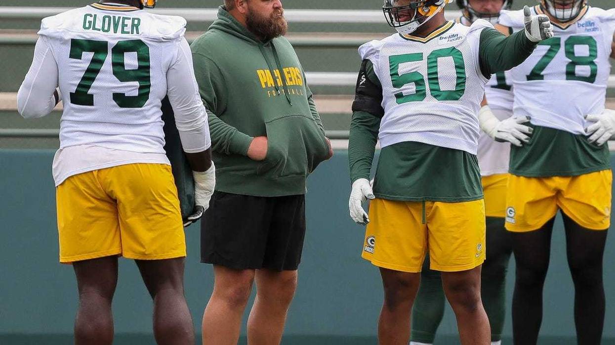 Green Bay Packers offensive lineman Zach Tom (50) talks with offensive line coach Luke Butkus between drill reps during practice on Thursday, August 8, 2024, at Ray Nitschke Field in Ashwaubenon, Wis. Tork Mason/USA TODAY NETWORK-Wisconsin