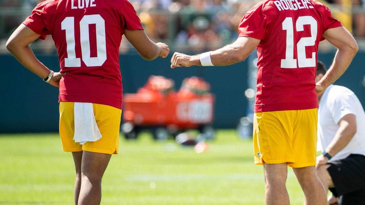 Green Bay Packers quarterback Jordan Love (10) and quarterback Aaron Rodgers (12) fist bump during the third day of training camp Friday, July 30, 2021 in Green Bay, Wisconsin. Love was Rodgers' backup for three seasons (2020-22).