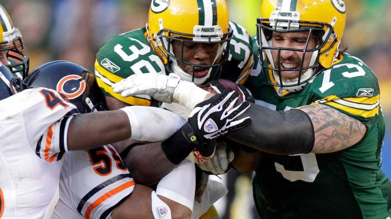 Green Bay Packers running back Brandon Jackson (32) gets some blocking help from guard Daryn Colledge during the first quarter against the Chicago Bears on Jan. 2, 2011, at Lambeau Field. COLLEDGE26p2