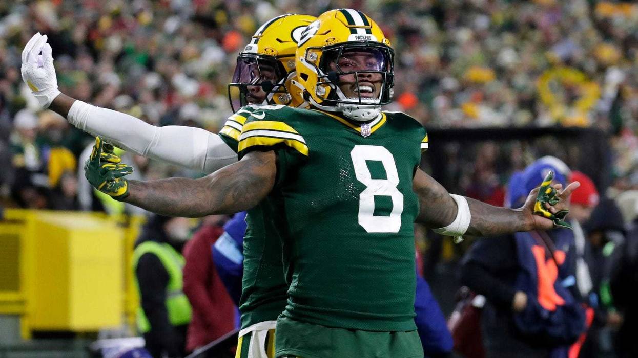 Green Bay Packers running back Josh Jacobs (8) celebrates scoring a touchdown with wide receiver Bo Melton (80) against the San Francisco 49ers during their football game Sunday, November 24, 2024, at Lambeau Field in Green Bay, Wisconsin.