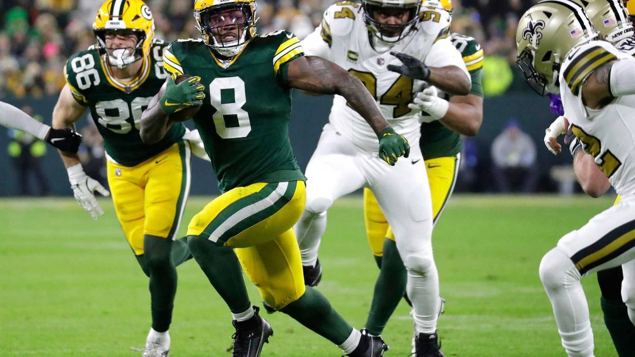 Green Bay Packers running back Josh Jacobs (8) runs for a first down against the New Orleans Saints during their football game Monday, December 23, 2024, at Lambeau Field in Green Bay, Wisconsin.