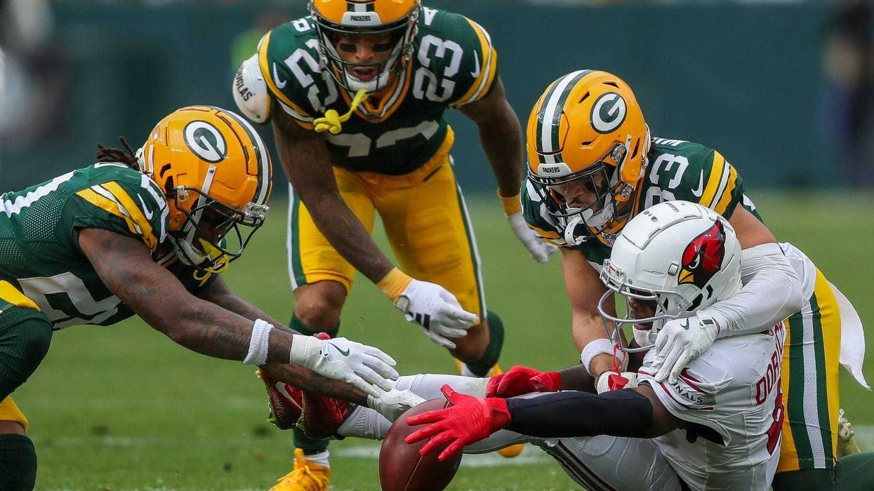 Green Bay Packers safety Javon Bullard (20), cornerback Jaire Alexander and safety Evan Williams (33) scramble to recover a fumble by Arizona Cardinals wide receiver Greg Dortch (4) on Sunday, October 13, 2024, at Lambeau Field in Green Bay, Wis. The Packers won the game, 34-13