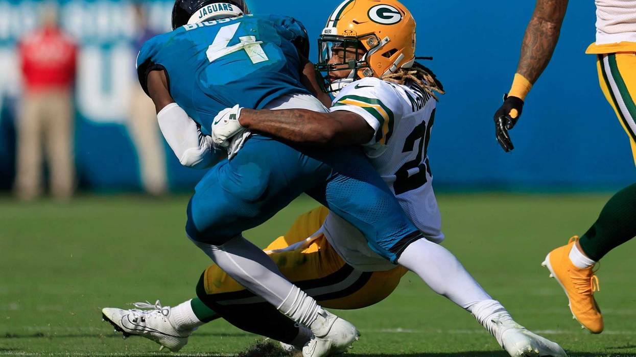 Green Bay Packers safety Xavier McKinney (29) tackles Jacksonville Jaguars running back Tank Bigsby (4) during the fourth quarter of an NFL football matchup Sunday, Oct. 27, 2024 at EverBank Stadium in Jacksonville, Fla. The Packers edged the Jaguars 30-27 on a last-second field goal