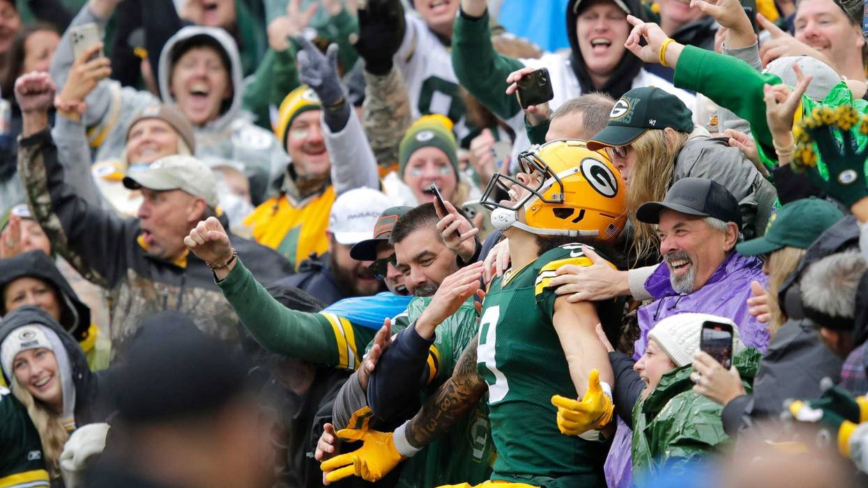 Green Bay Packers wide receiver Christian Watson (9) celebrates scoring a touchdown with a Lambeau Leap in the second quarter agains the Arizona Cardinals during their football game Sunday, October 13, 2024, at Lambeau Field in Green Bay, Wisconsin.