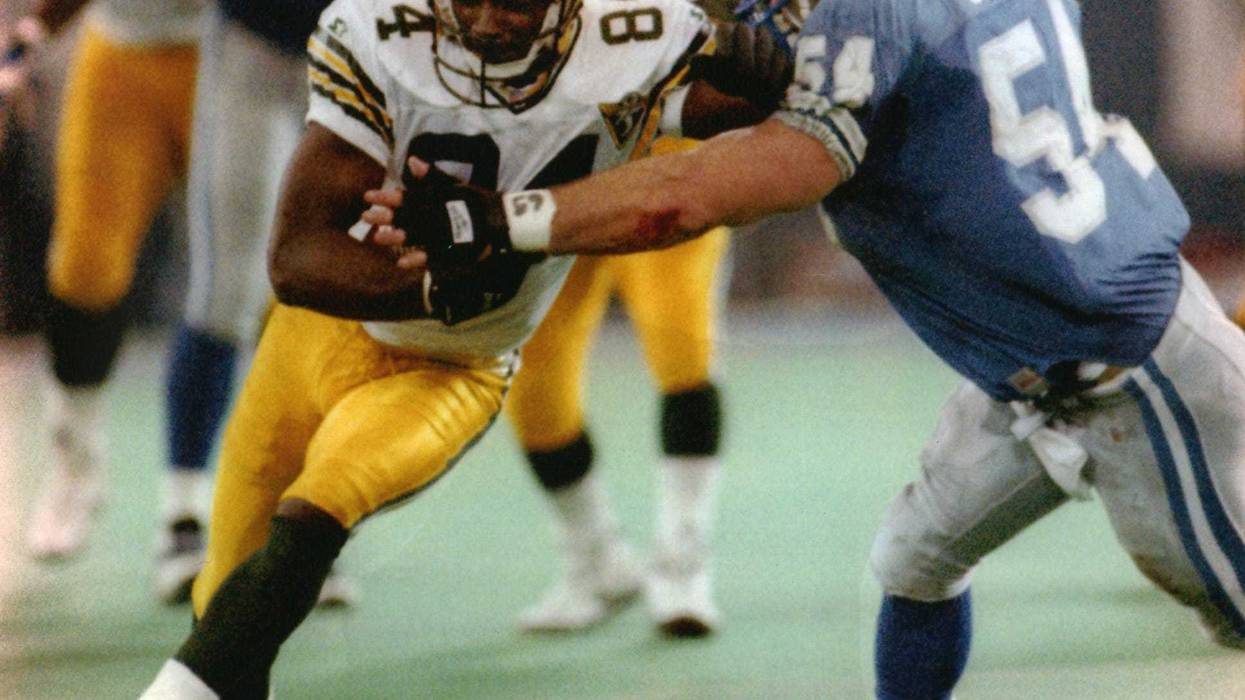 Green Bay Packers wide receiver Sterling Sharpe tries to elude Chris Spielman of the Detroit Lions after catching his 109th pass of the season during the second quarter of their game on January 1, 1994. Sharpe broke his NFL record of 108 with the catch.