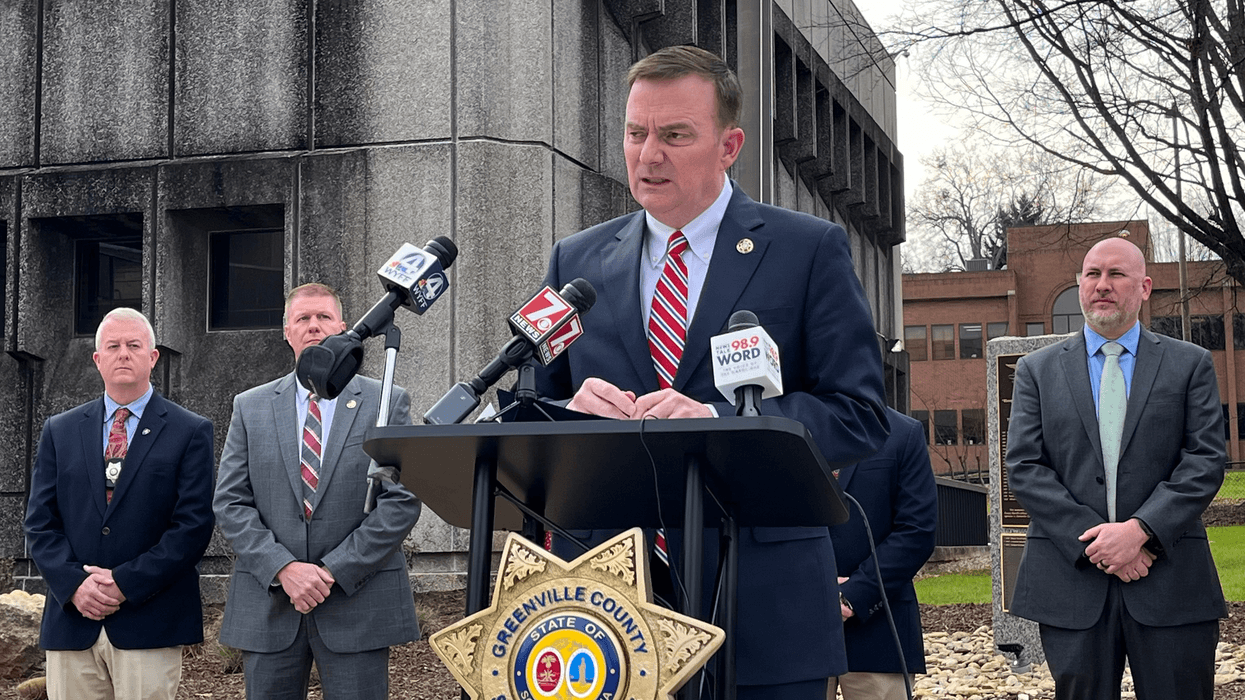 Greenville County Sheriff Hobart Lewis speaking at a press conference flanked by members of the GCSO Cold Case investigation unit