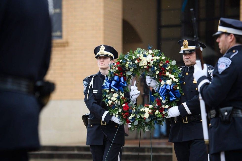 Greenville Police Department honor guard officers place a wreath next to a squad vehicle during a memorial service for officer Allen Jacobs at Bob Jones University Thursday, March 18, 2021.