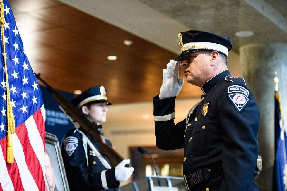 Greenville Police Department honor guard officers prepare to change guard detail during a memorial service for former officer Allen Jacobs in honor of Jacobs