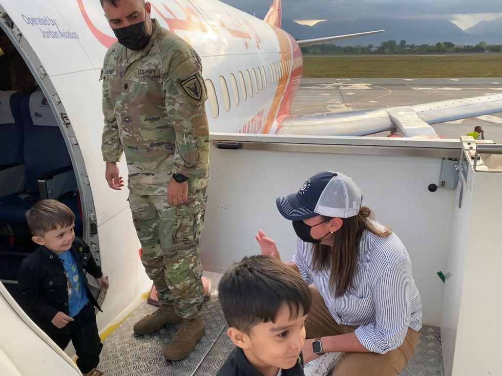 greeting two young boys off a second plane bringing evacuated Afghans SoA is supporting here in Albania (w/ the Office of Defense Cooperation Chief)