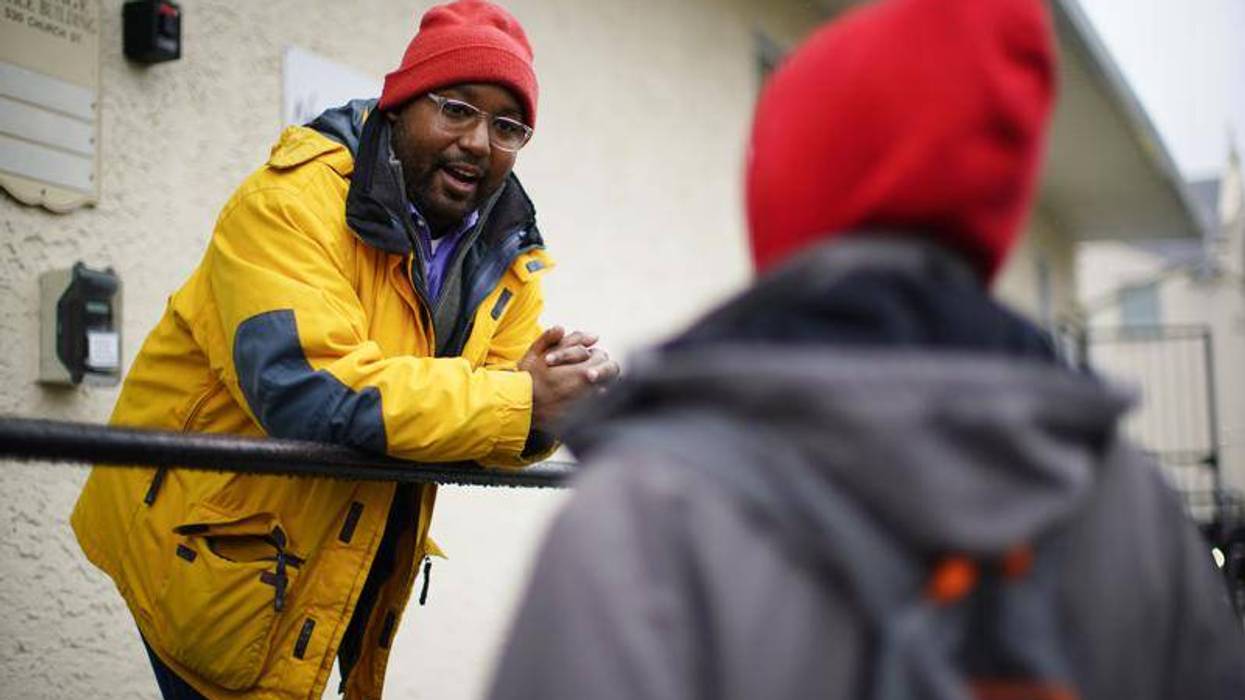 Greg Scott, a newly-elected Democratic member of Pennsylvania's House of Representatives, speaks with a person outside the Hospitality Center which helps people experiencing homelessness and poverty, in Norristown, Pa., Dec. 22, 2022. Scott is part of what House Democrats say is the most diverse incoming class of lawmakers in state history.