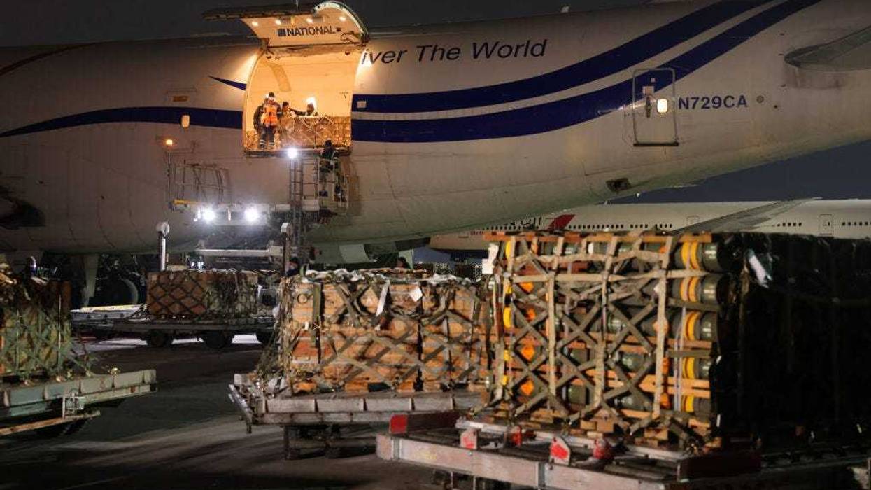 Ground personnel unload weapons, including Javelin anti-tank missiles, and other military hardware delivered on a National Airlines plane by the United States military at Boryspil Airport near Kyiv on January 25, 2022 in Boryspil, Ukraine. The shipment comes as tensions between the NATO military alliance and Russia are intensifying due to Russia's move of tens of thousands of troops as well as heavy weapons to the Ukrainian border, causing international fears of a possible Russian invasion of Ukraine. The U.S., Great Britain and other NATO countries have sent arms in recent days to Ukraine in a bid to deter an invasion. (Photo by Sean Gallup/Getty Images)