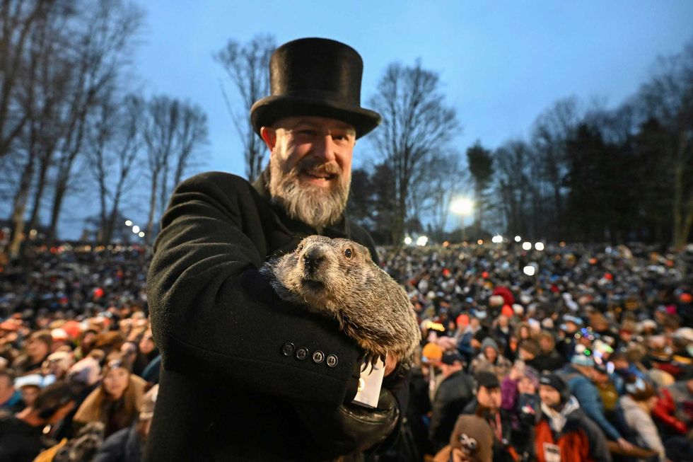 Groundhog Club handler A.J. Dereume holds Punxsutawney Phil, the weather prognosticating groundhog, during the 138th celebration of Groundhog Day on Gobbler