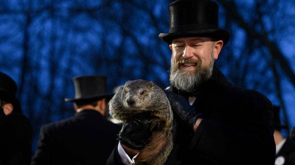 Groundhog handler AJ Dereume holds Punxsutawney Phil after he did not see his shadow predicting an early Spring during the 138th annual Groundhog Day festivities on Friday February 2, 2024 in Punxsutawney, Pennsylvania.
