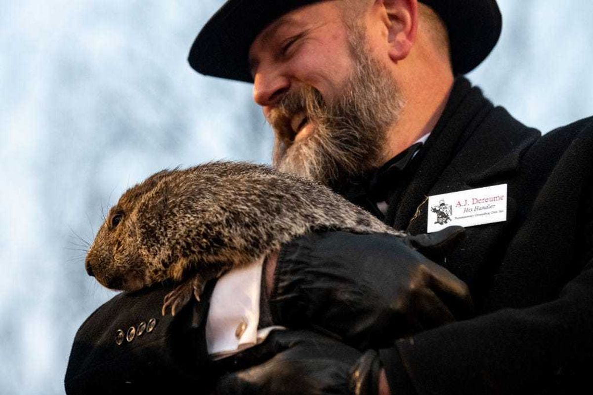 Groundhog handler AJ Dereume holds Punxsutawney Phil, who saw his shadow, predicting a late spring during the 137th annual Groundhog Day festivities on February 2, 2023 in Punxsutawney, Pennsylvania.