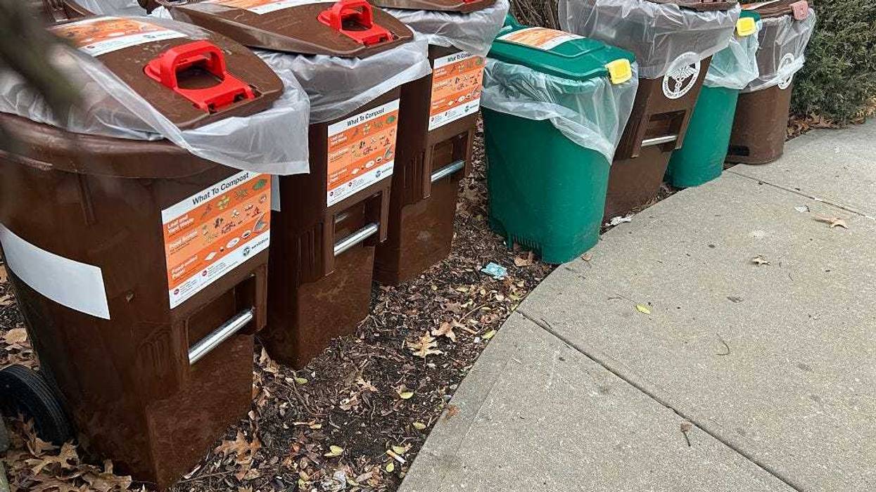 Group of compost bins outside apartment building in residential area of Queens, New York.