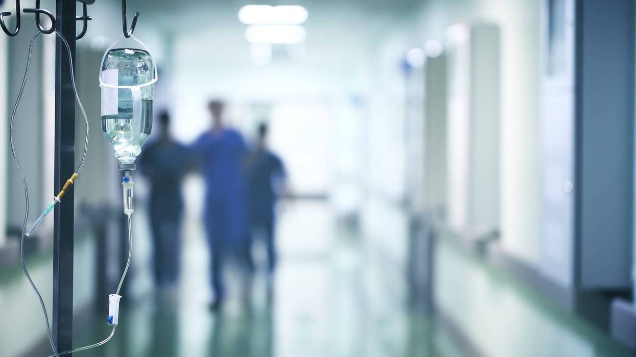 Group of doctors in a hurry down the hospital hallway